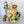 Load image into Gallery viewer, Safari-themed birthday cake with animal figurines including a lion, giraffe, elephant, monkey, and zebra, leafy decorations, and gold details.”