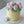 Load image into Gallery viewer, Buttercream birthday cake decorated with pink roses and green leaves on a pale yellow base. Elegant floral design.