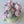 Load image into Gallery viewer, Top view of floral birthday cake with pink buttercream roses and green leaves arranged in a lush bouquet shape