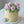 Load image into Gallery viewer, Buttercream cake topped with a crown of pink rose-shaped flowers and green leaves, with a matching flower on the base