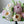 Load image into Gallery viewer, Close-up of realistic buttercream flowers in pastel shades of white, cream, yellow, and pink arranged like a floral bouquet.