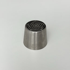 metallic tool with decorative top on a light gray background