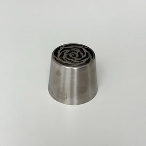 metallic stamp with rose pattern on a light gray background