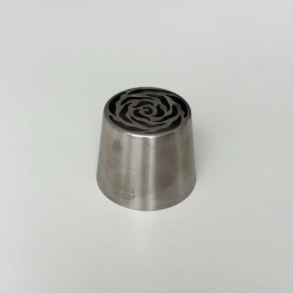 metallic stamp with rose pattern on a light gray background