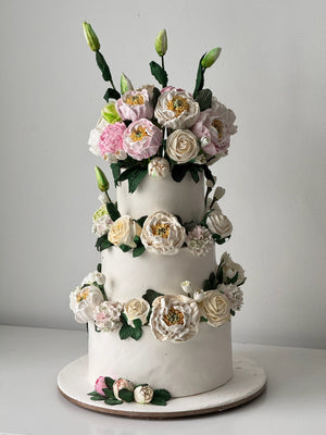 handmade marshmallow flower decorated tiered cake with large floral topper