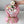 Load image into Gallery viewer, Bouquet of marshmallow flowers wrapped in pink paper with a green ribbon, held by a hand.
