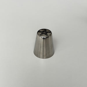 metallic baking tool with star-shaped design on a gray background