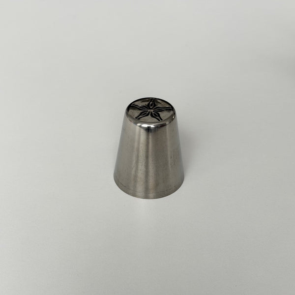 metallic baking tool with star-shaped design on a gray background