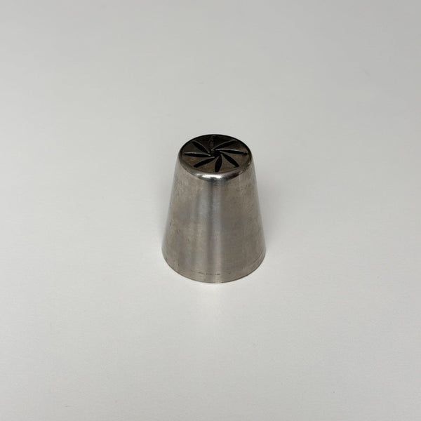 metallic baking tool with star-shaped end on a light gray background