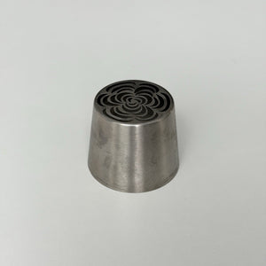 metallic cone-shaped object with a textured top on a light gray background