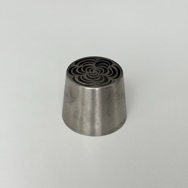 metallic cone-shaped object with a textured top on a light gray background