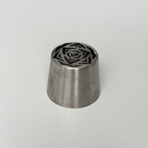 metallic tool with a rose pattern on a gray background