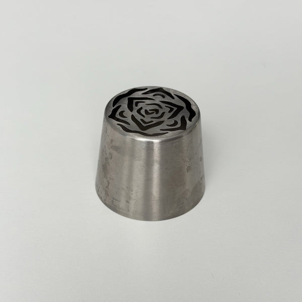 metallic tool with a rose pattern on a gray background