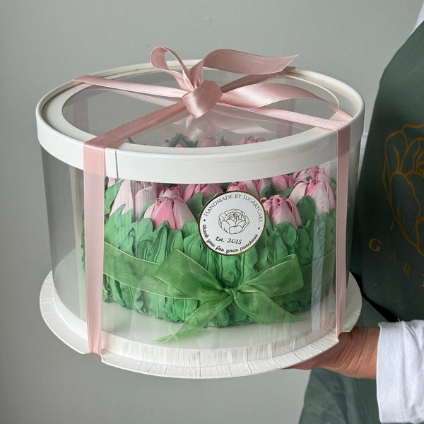 decorative tulip flower cake packaged in clear round box with pink bow