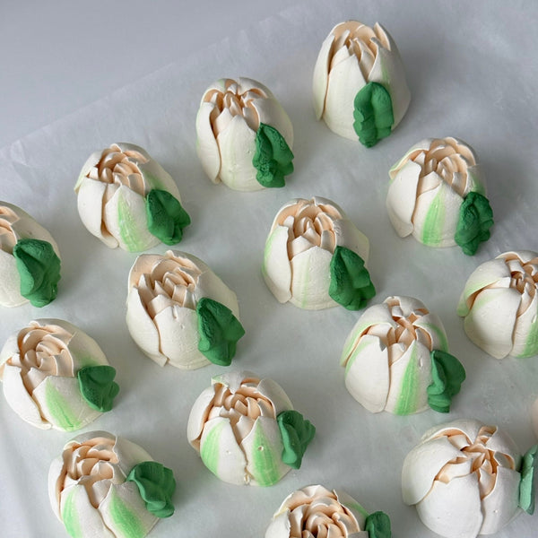 edible marshmallow tulip toppers arranged on a white background