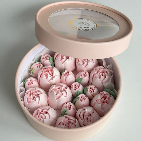 open round pink gift box filled with edible pink sugar flowers shaped like tulips with green leaves cake topper cake decoration sugar flowers 