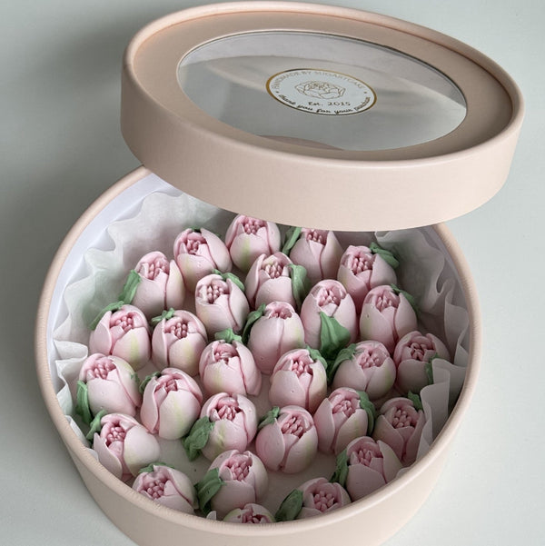 Marshmallow flowers in gift box on a light gray background