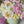 Load and play video in Gallery viewer, handmade marshmallow flower bouquet cake with pink, white and yellow blooms and green leaves arranged in a pastel green box, held in gloved hands
