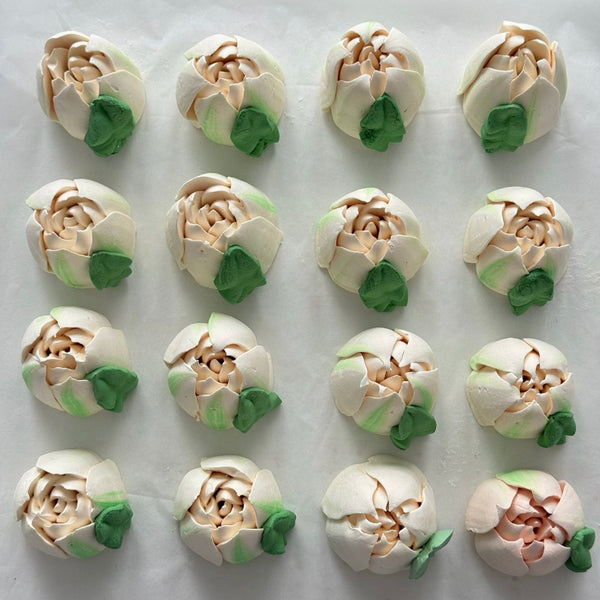 Edible marshmallow tulip flowers arranged in rows on a white background
